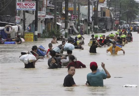 Residents evacuate to safer grounds as massive flooding continues for the second day Saturday&nbsp;at Calumpit township, Bulacan province north of Manila, Philippines.